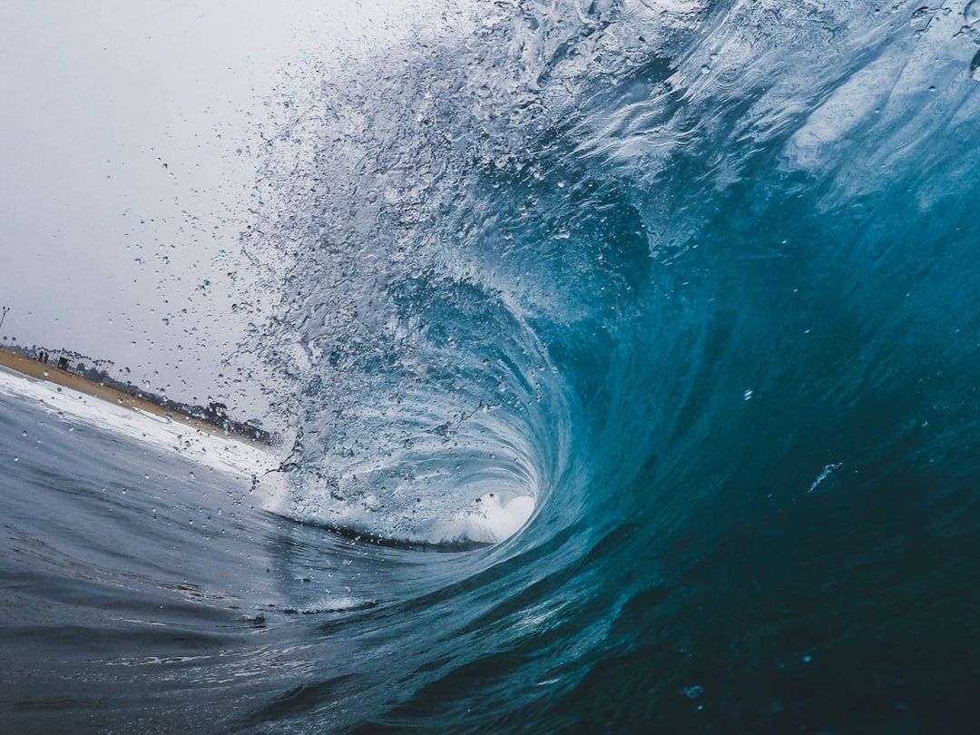 Close-up view inside a curling turquoise ocean wave
